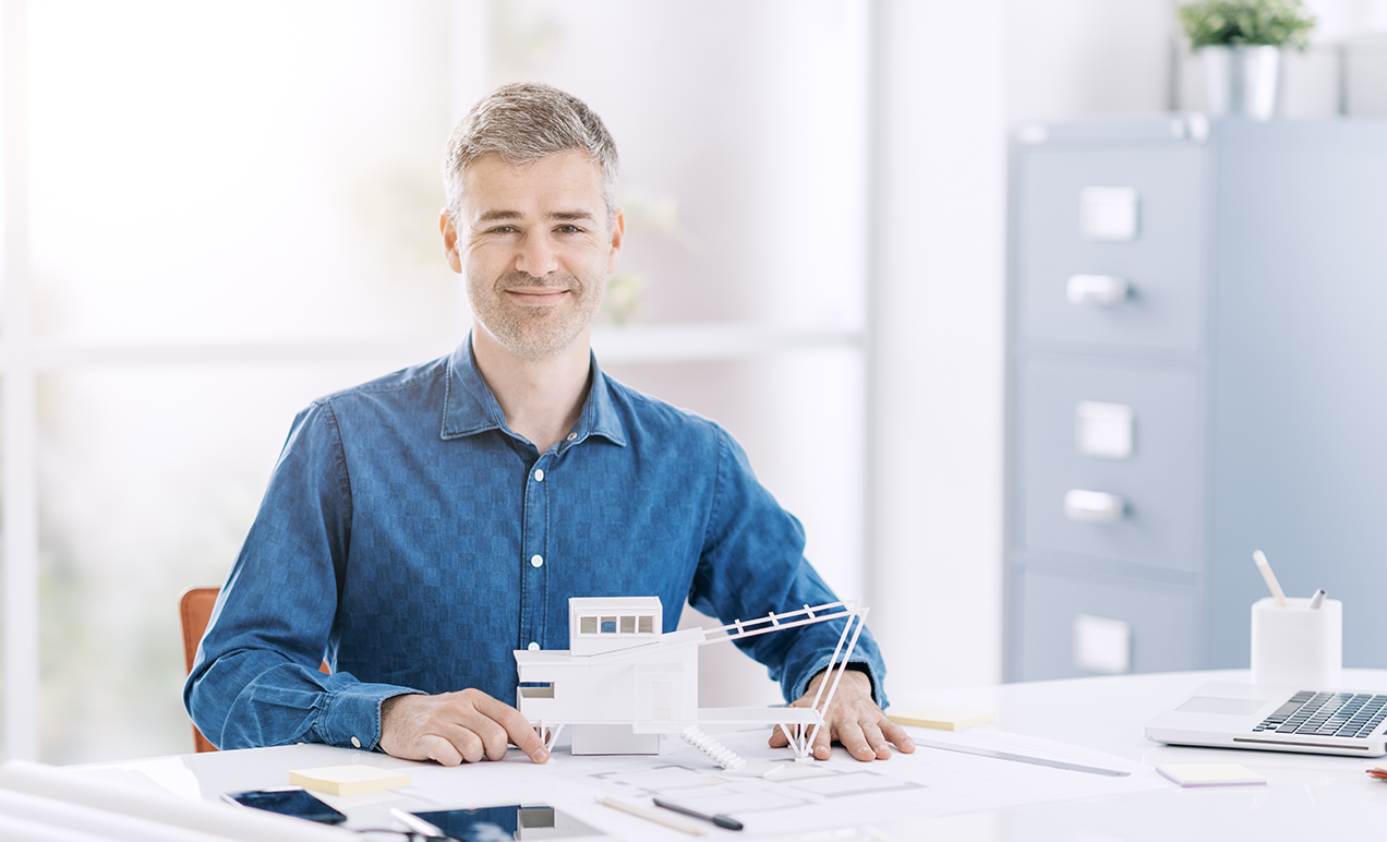 Architect reviewing blueprints in office workspace