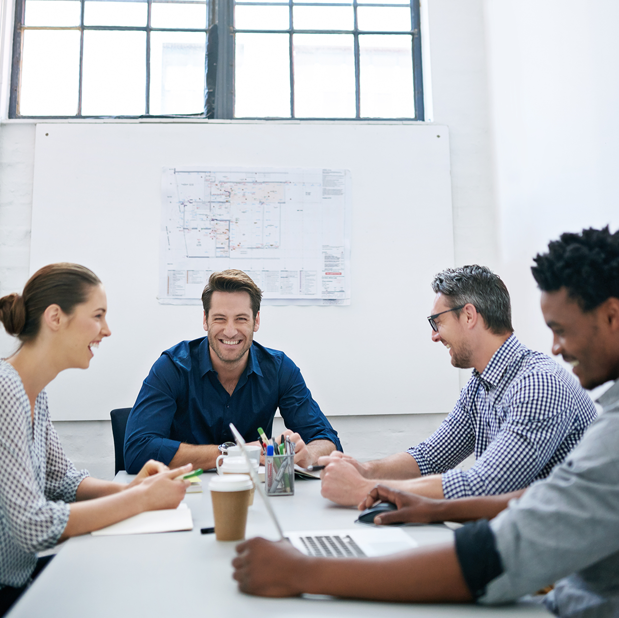 Architectural team collaborating on project plans at table