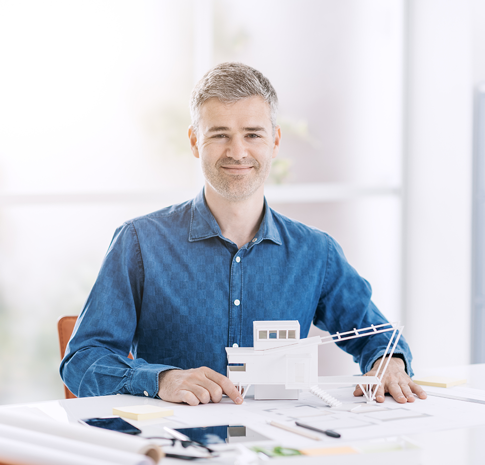 Architect sitting in desk with plans